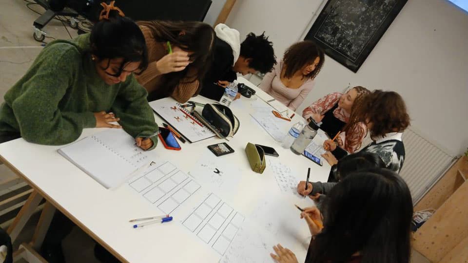 7 Students sat round a table, working together