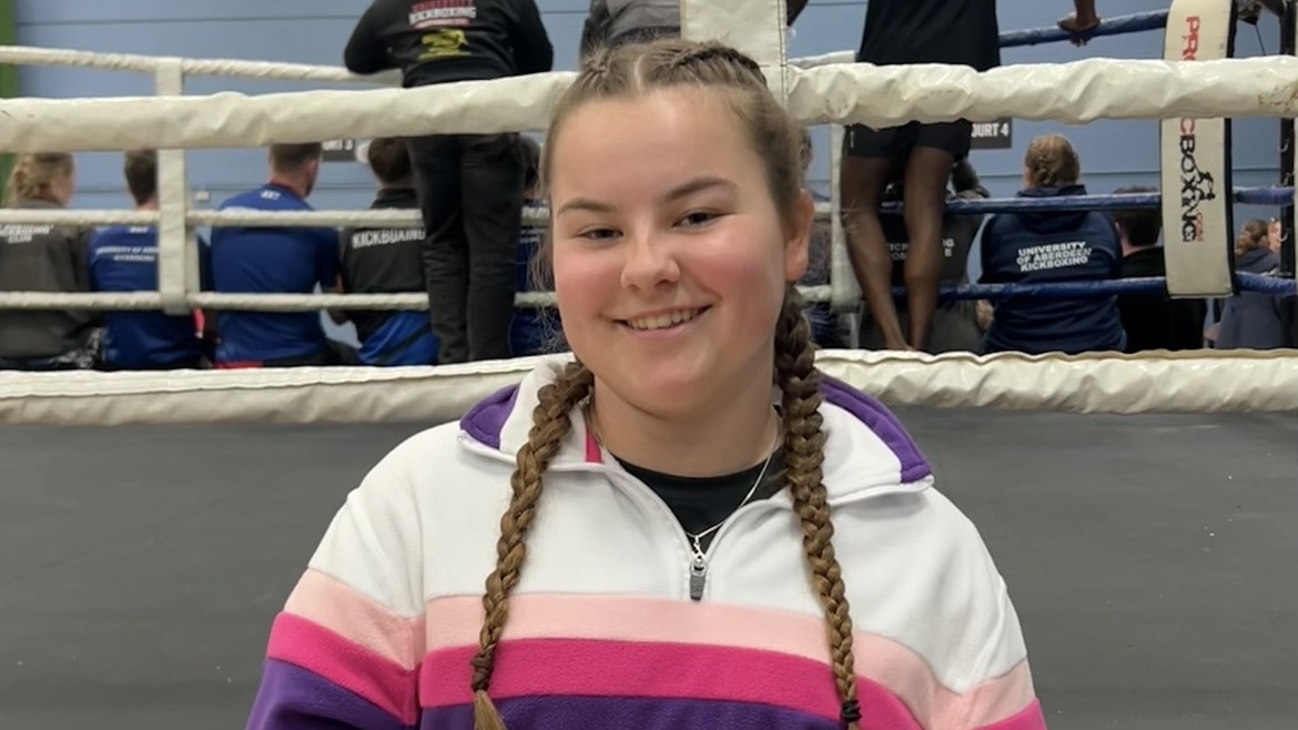 Hannah stood next to a boxing ring