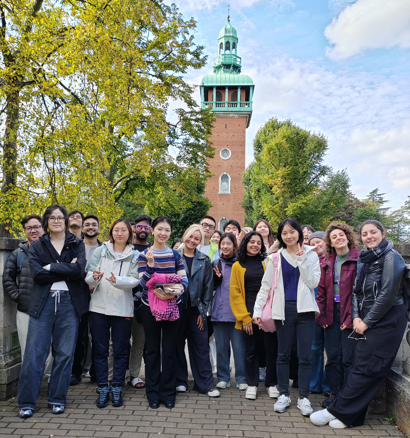 A group photo from an ISE event in Queen's Park, Loughborough, in front of the Carillon tower