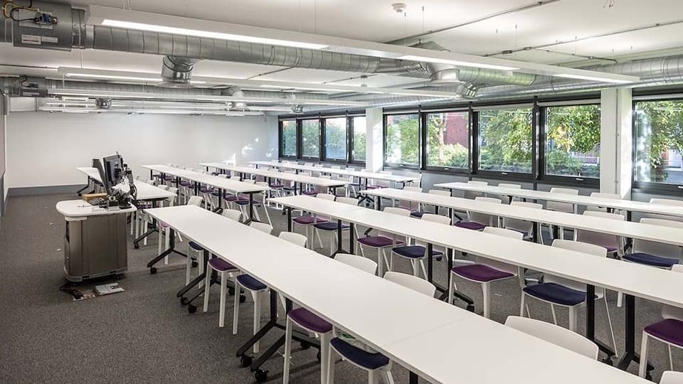 Keith Green Teaching Hub - KTG004 - wide teaching space with 4 rows of white desks