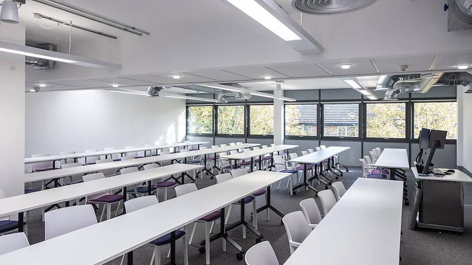 Keith Green Teaching Hub - KTG102 - first floor teaching space with several rows of white desks and plenty of natural light