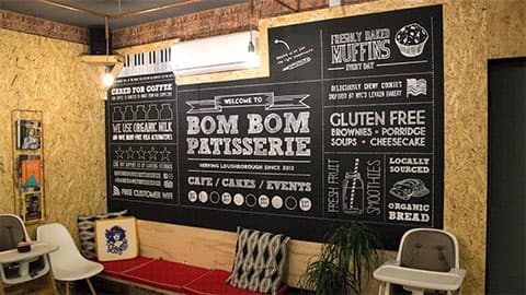 Black board which reads Bom Bom Patisserie