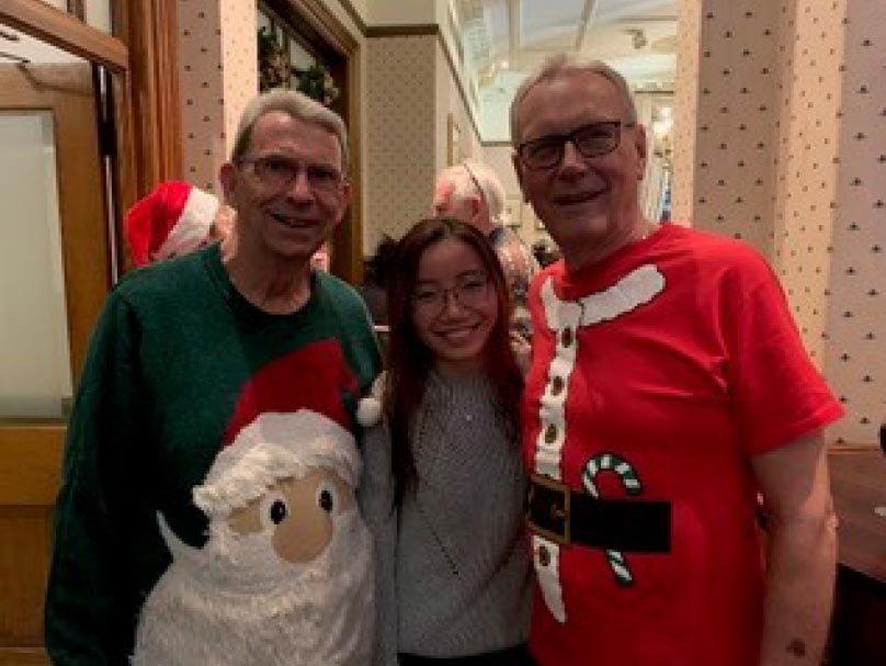 Malissa with two colleagues at a Christmas dinner