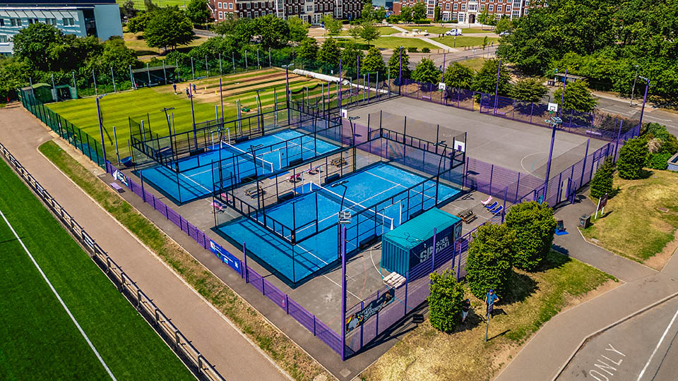 Padel courts are being used in the sunshine.