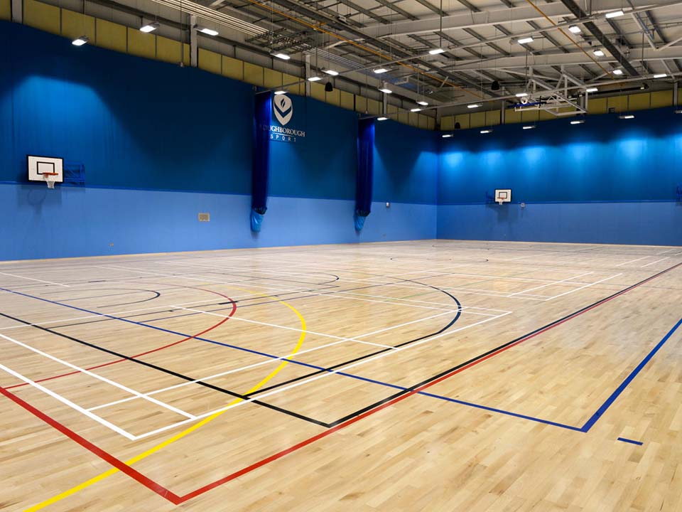 A sports hall with lines on the floor for different sports.
