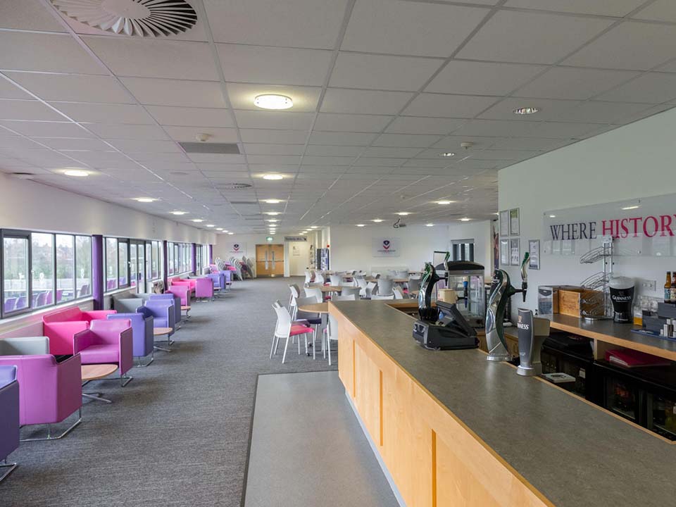 A big open function room with a bar and tables.
