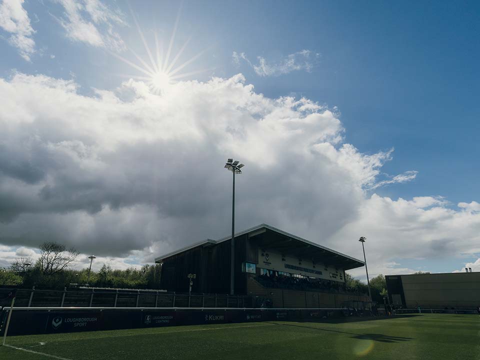 A football pitch with a stand on one side.