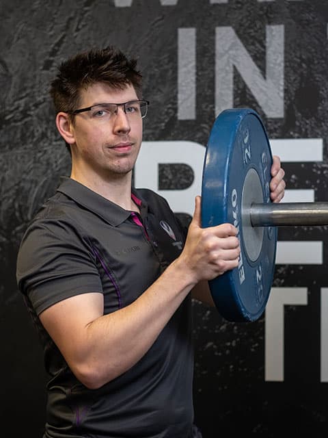 Fitness Instructor Paul fitting a weight