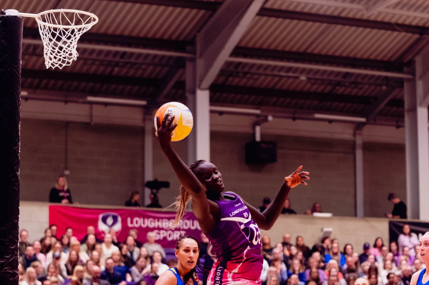 Mary Cholhok contesting a high ball under the shooting post