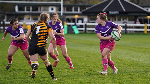 close up of women's rugby players on the pitch