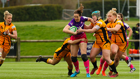 close up of women's rugby players on the pitch