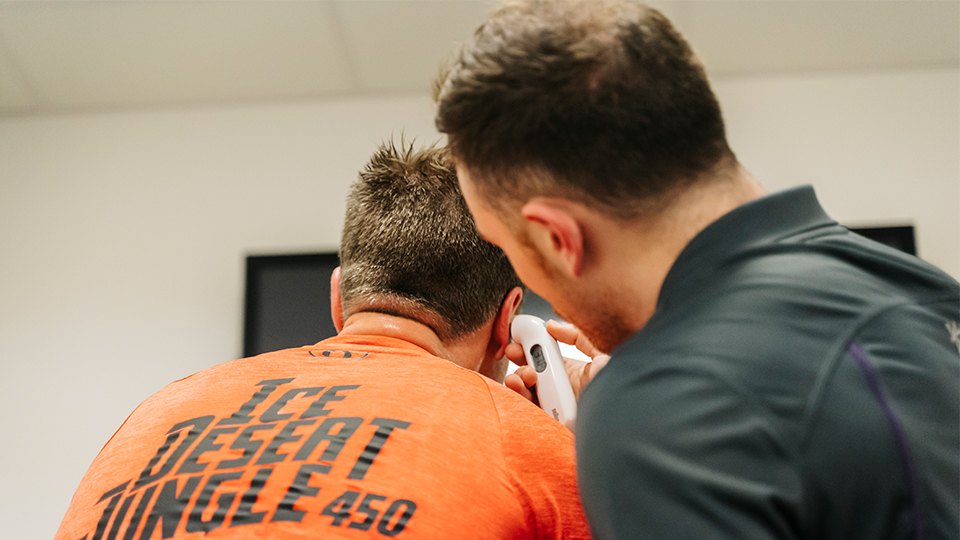 two men in a lab seen from behind