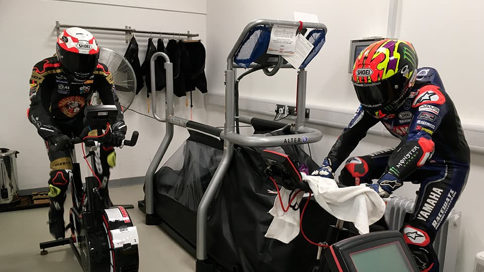 two motorcyclists being assessed in a heat chamber