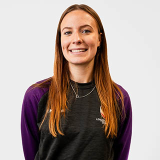 Hannah is wearing a Loughborough Sport jumper and is smiling for a headshot.