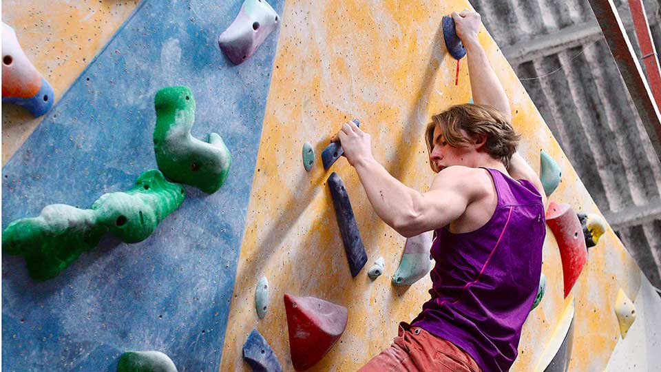 a person climbing an indoor climbing wall