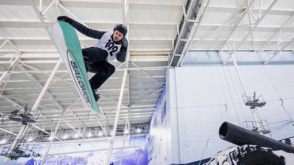 A snowboarder about to start a race on the slopes