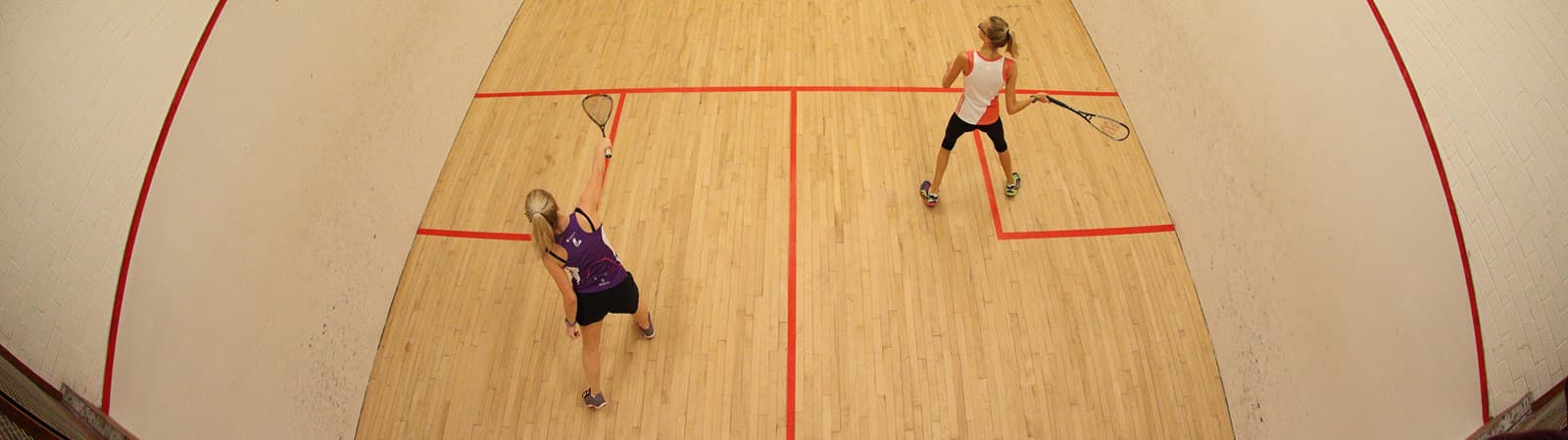 two women playing squash