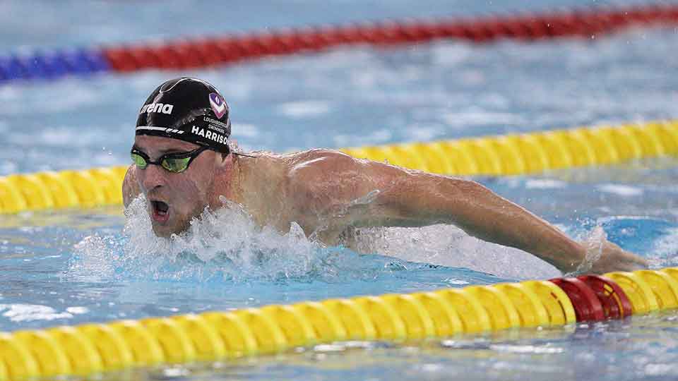 Ben, mid stroke, swimming in a pool