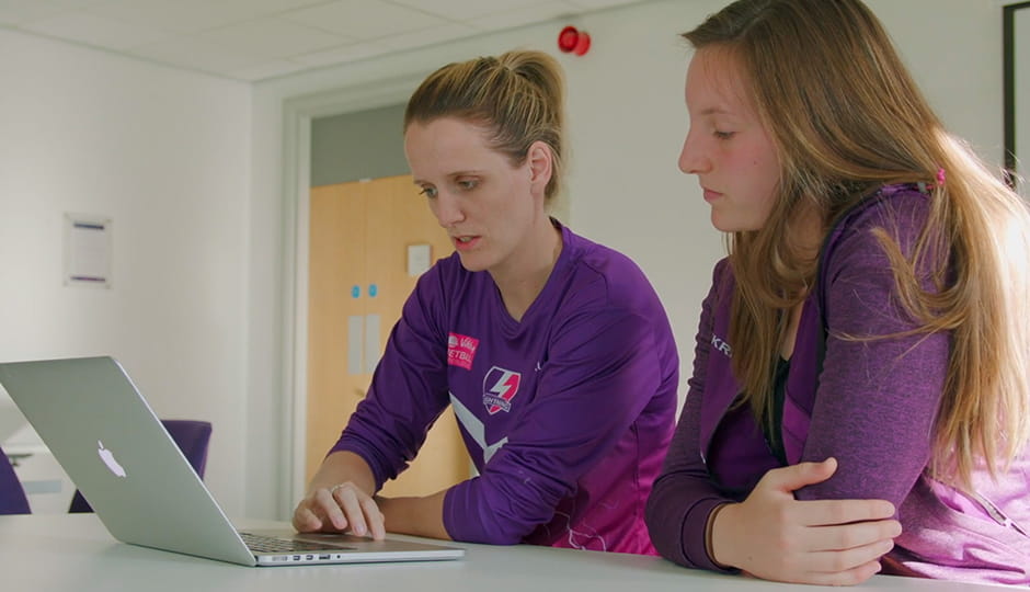 two women looking at a laptop screen