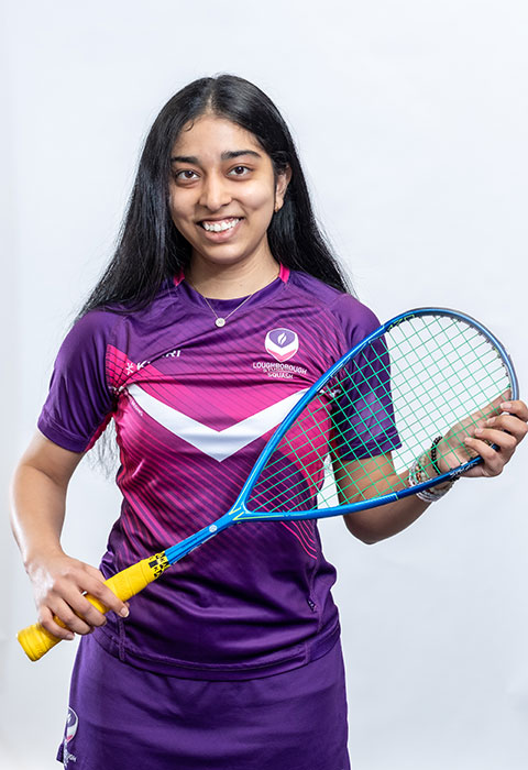 Headshot of Sanika holding a squash racket