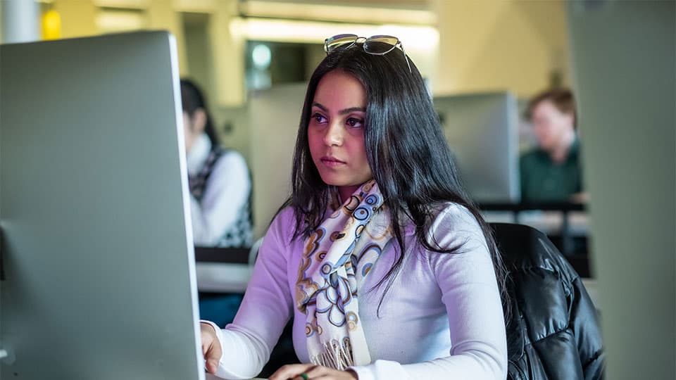 a student looking at the computer screen