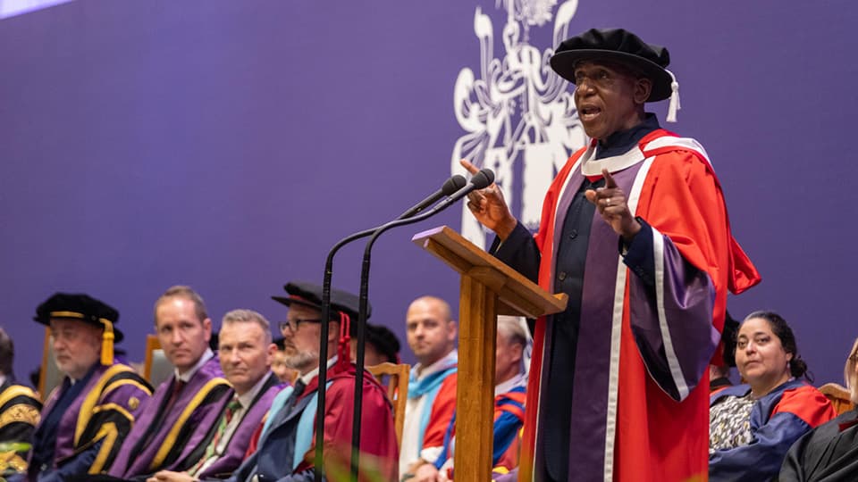 Colin McFarlane delivering lecture to graduands in Summer 2025 as part of receiving his DUniv honorary degree.