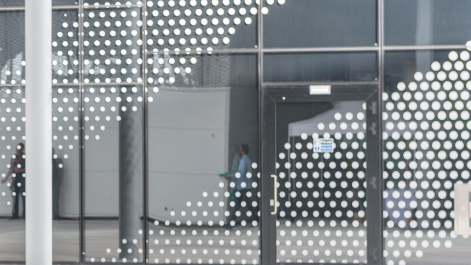 distant figures behind a glass wall