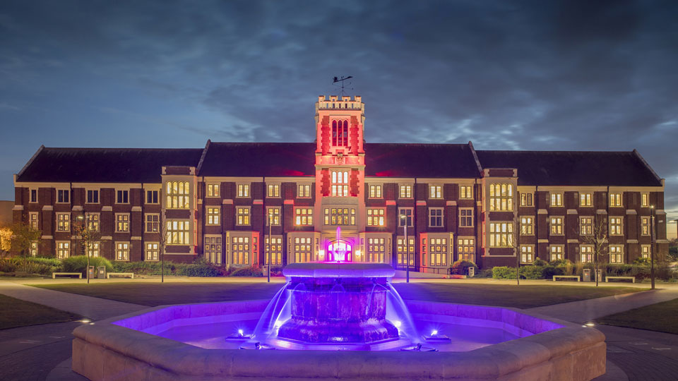 the fountain and Hazlerigg floodlit at night