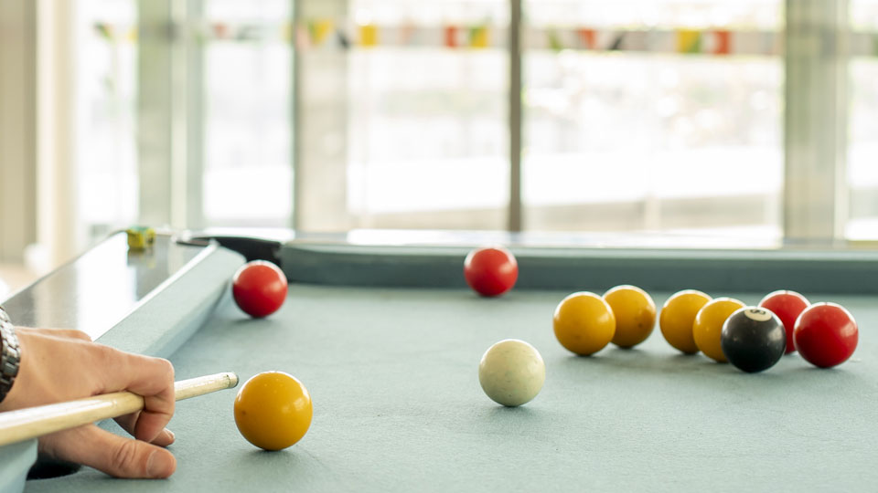 close up of a person playing snooker