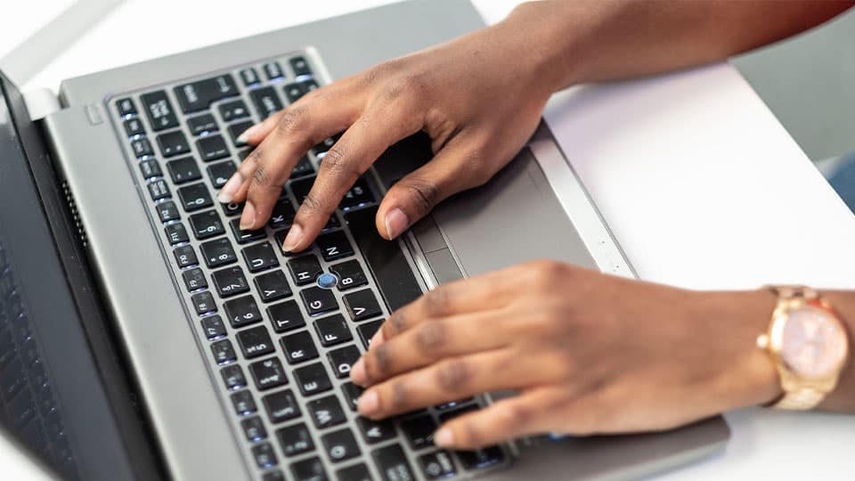 hands over a laptop keyboard