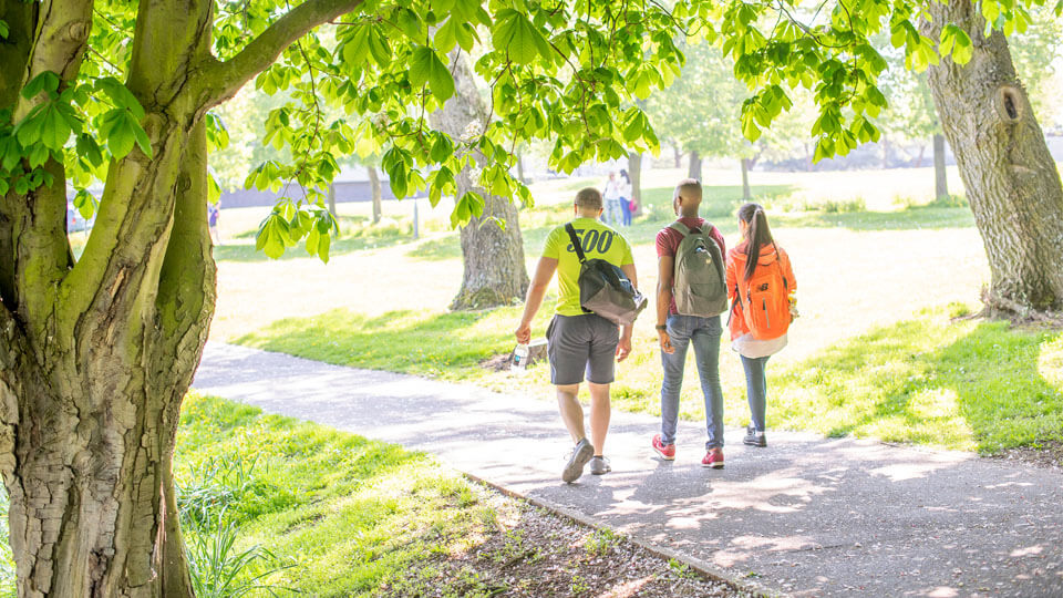 three students walking on campus