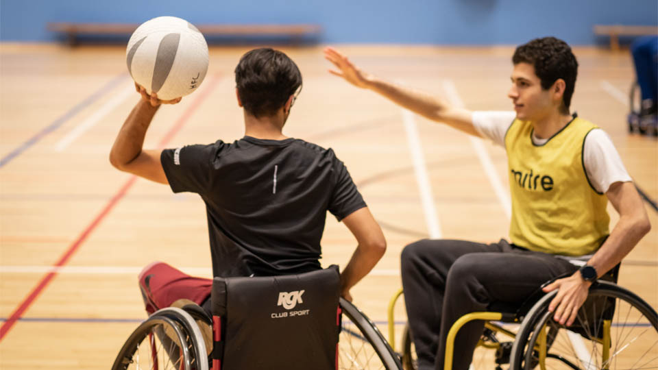 two wheelchair basketball players in action