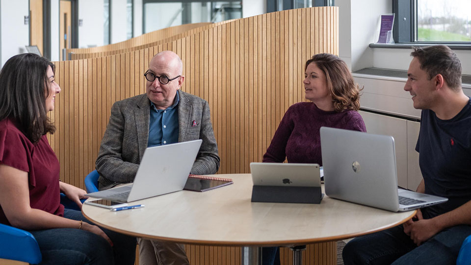 Staff and students in discussion in the Business School