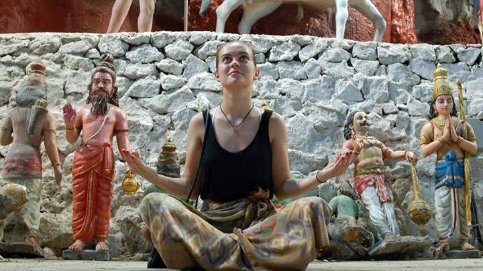 Harriet Shepherd sitting cross legged on the ground whilst in Singapore