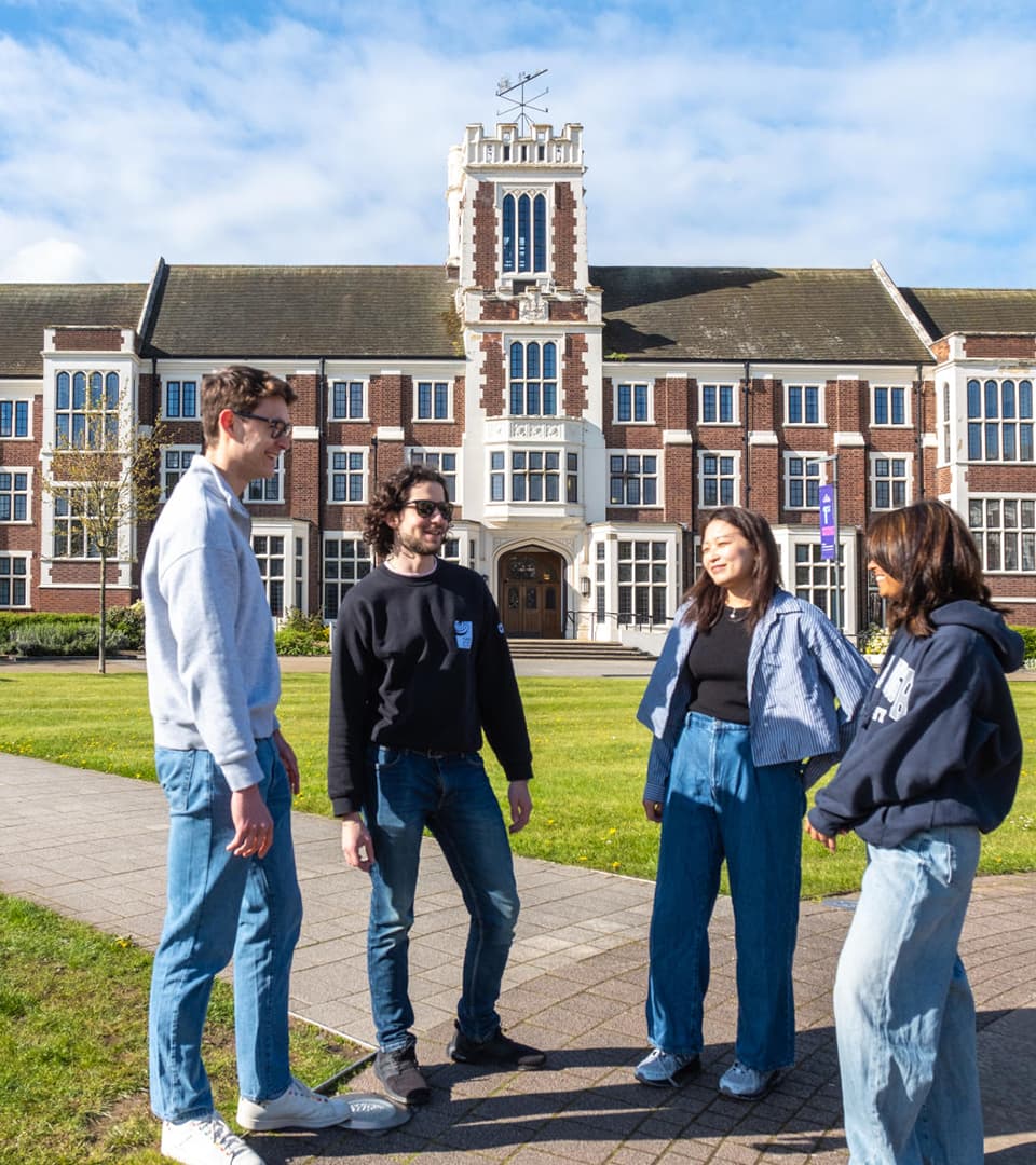 A group of 4 students outdoors having a conversation