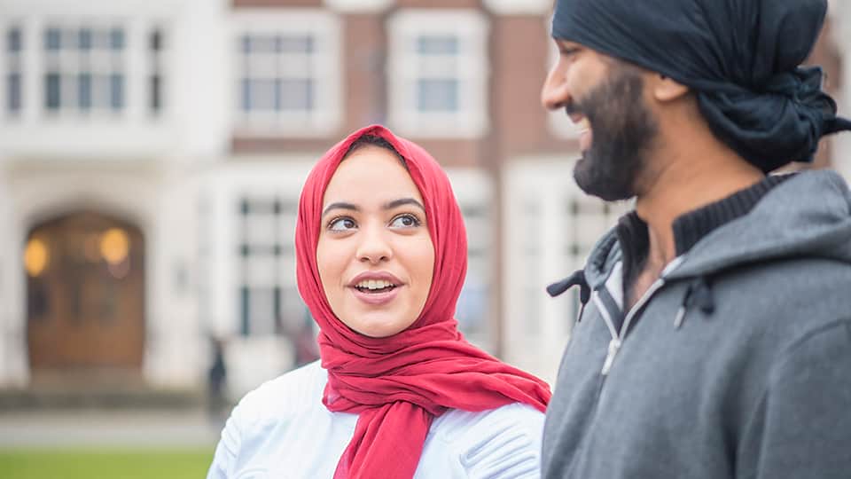 Students talking in front of Hazlerigg Building