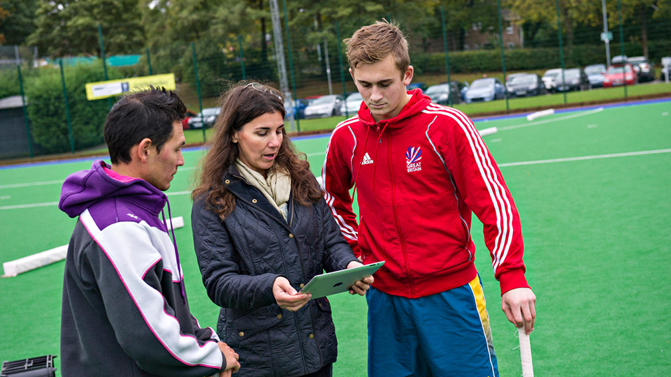 Prof Jowett talking to an athlete and his coach