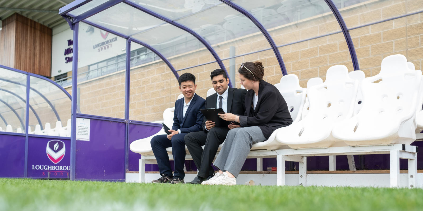 Three students looking at screen