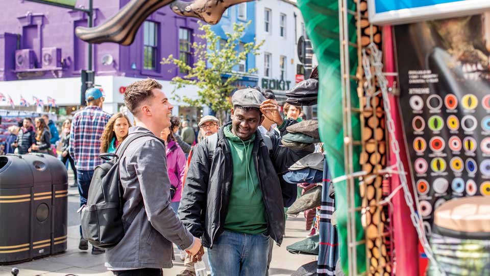people walking around an outdoor market