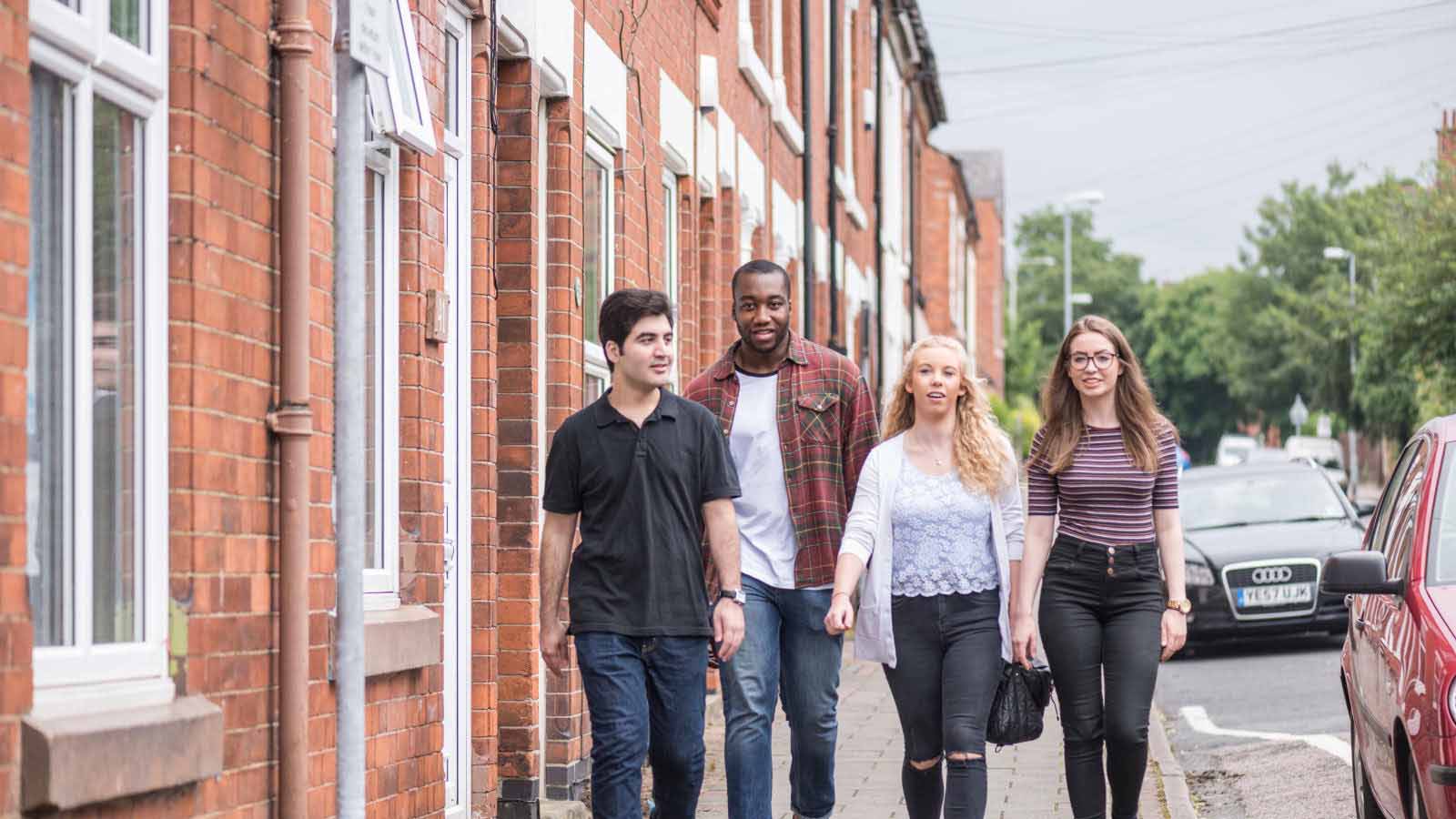 Students walking in town, past private student accomodation