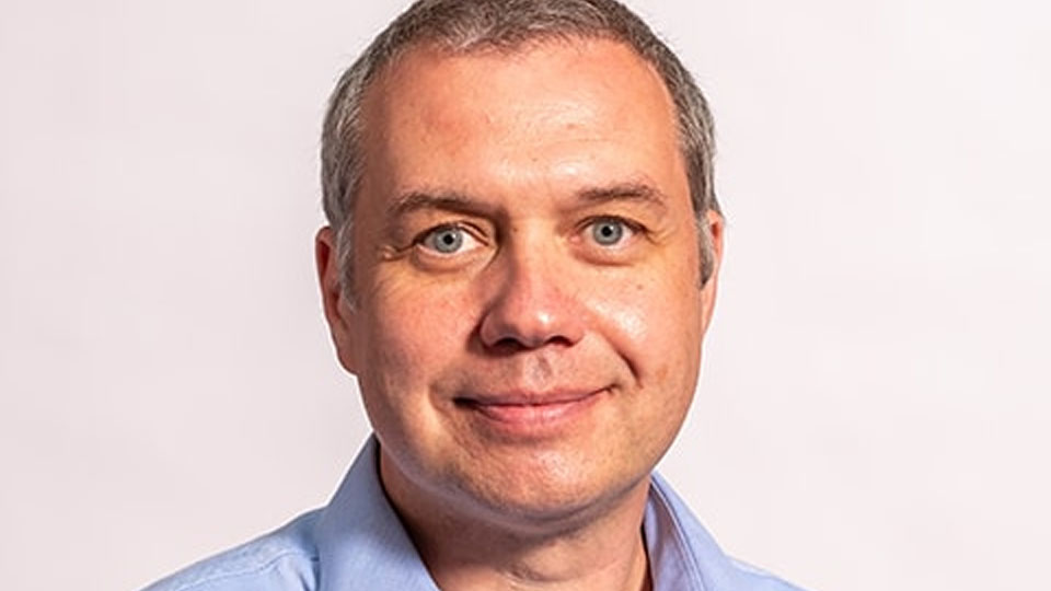 Portrait photo of an academic, David Allinson, on a white background