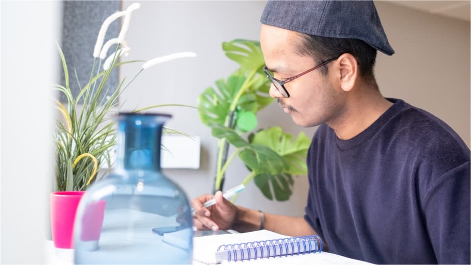 A student studying in their room