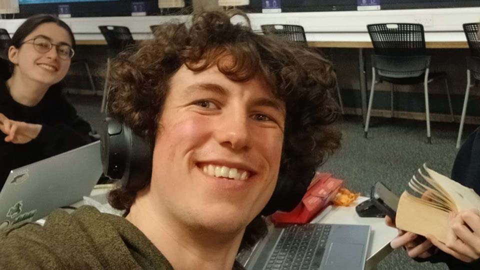 Ben Keene wearing headphones and smiling to the camera