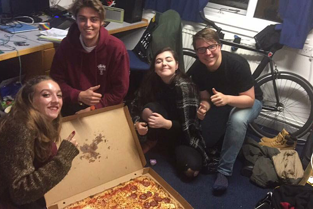 Tara and her flat mates eating pizza. 