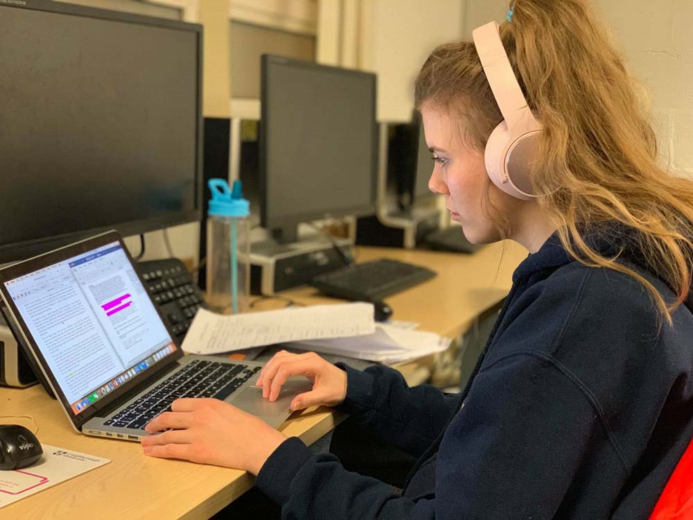 Emma's friend Caroline doing coursework on her laptop. 