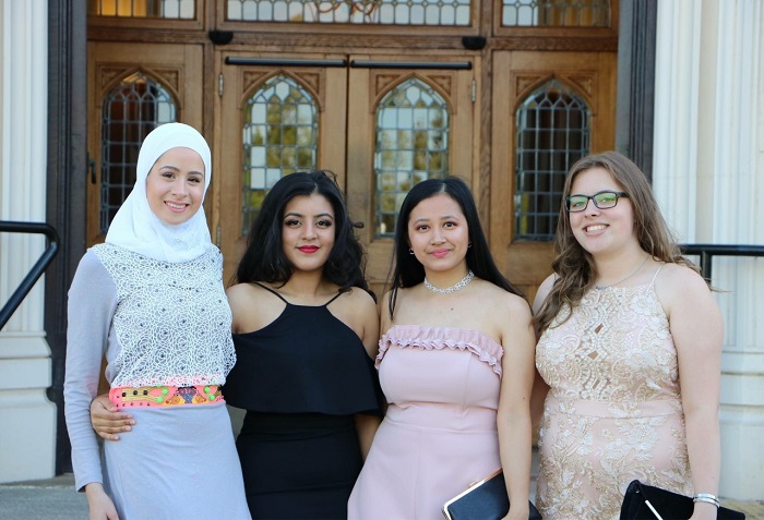 Leah and three friends standing outside the doors of Hazlerigg before summer ball. 