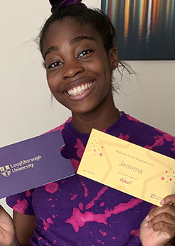 Photograph of Jemima holding her golden ticket sent from Loughborough University. 