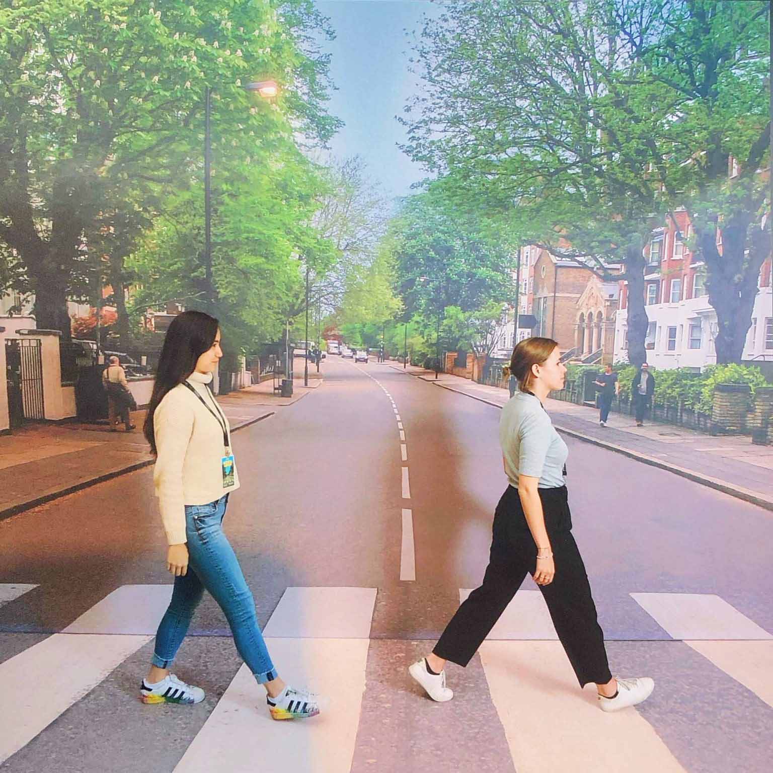 Lety and a colleague in front an Abbey Road backdrop which was made famous by The Beatles album cover. 