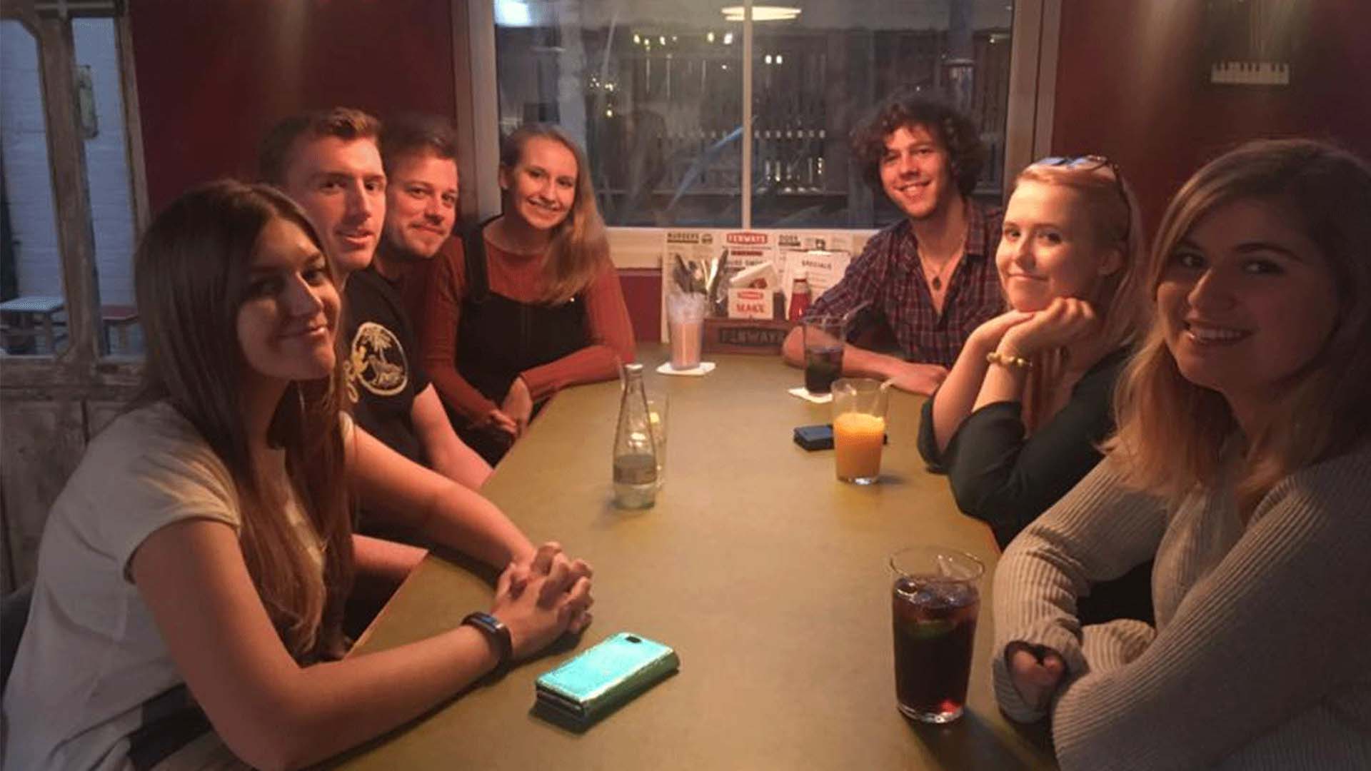 Hannah and six of her friends at a restaurant.  