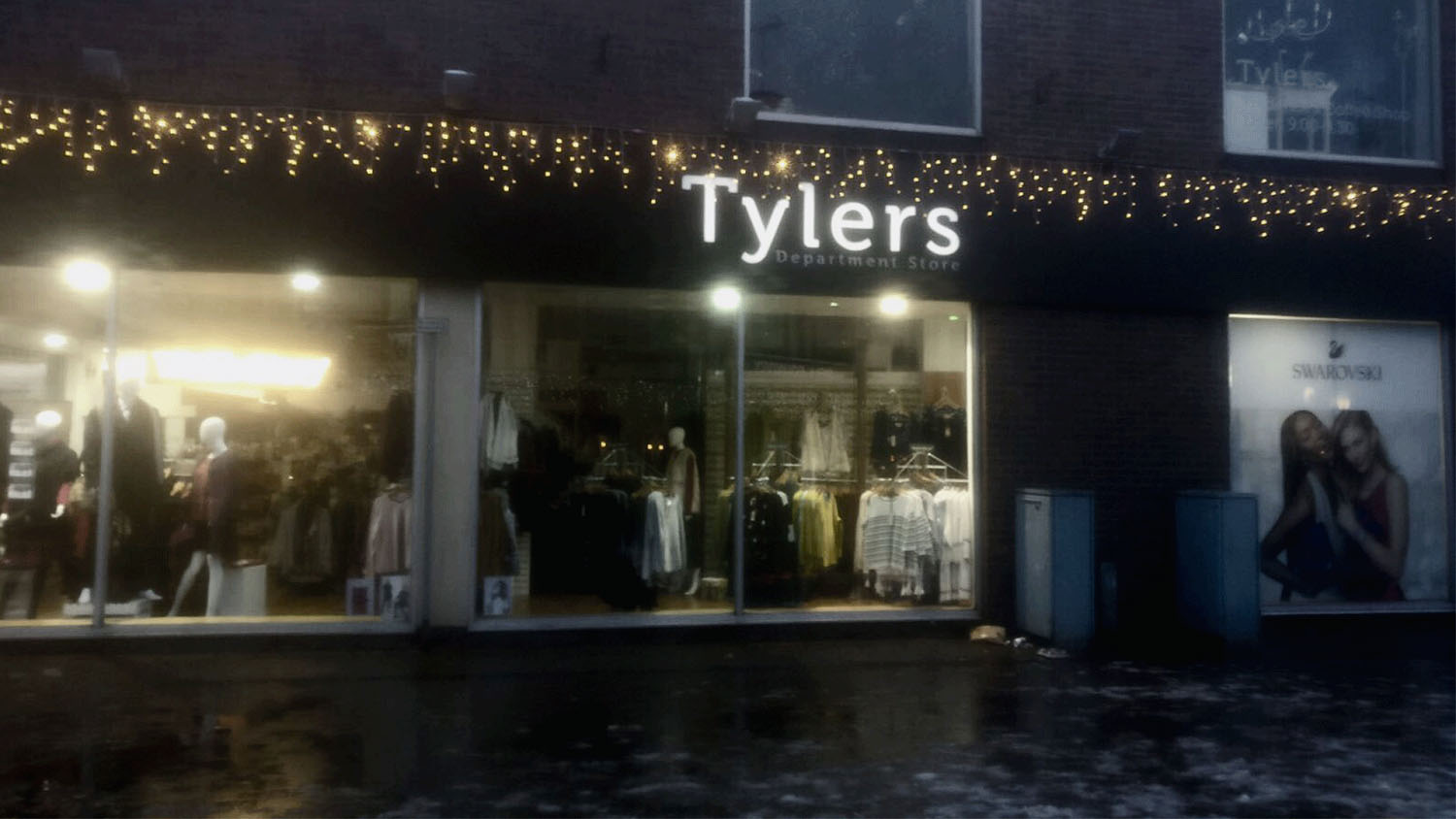 The shop Tylers in Loughborough town centre. The shop has a glass windows at the front with the word 'Tylers' written in white on a black background above the windows. 